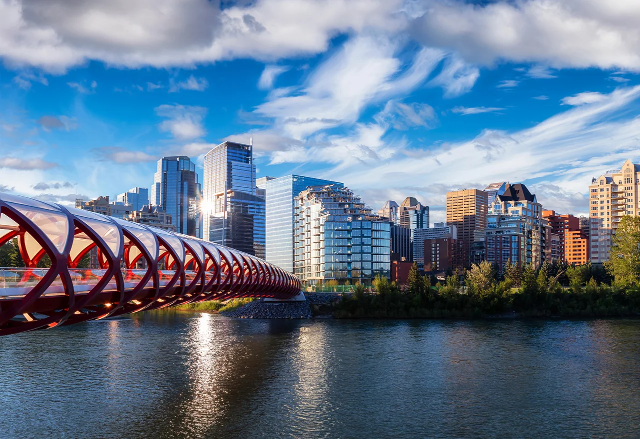 The Peace Bridge over the Bow River with the downtown Calgary skyline behind it