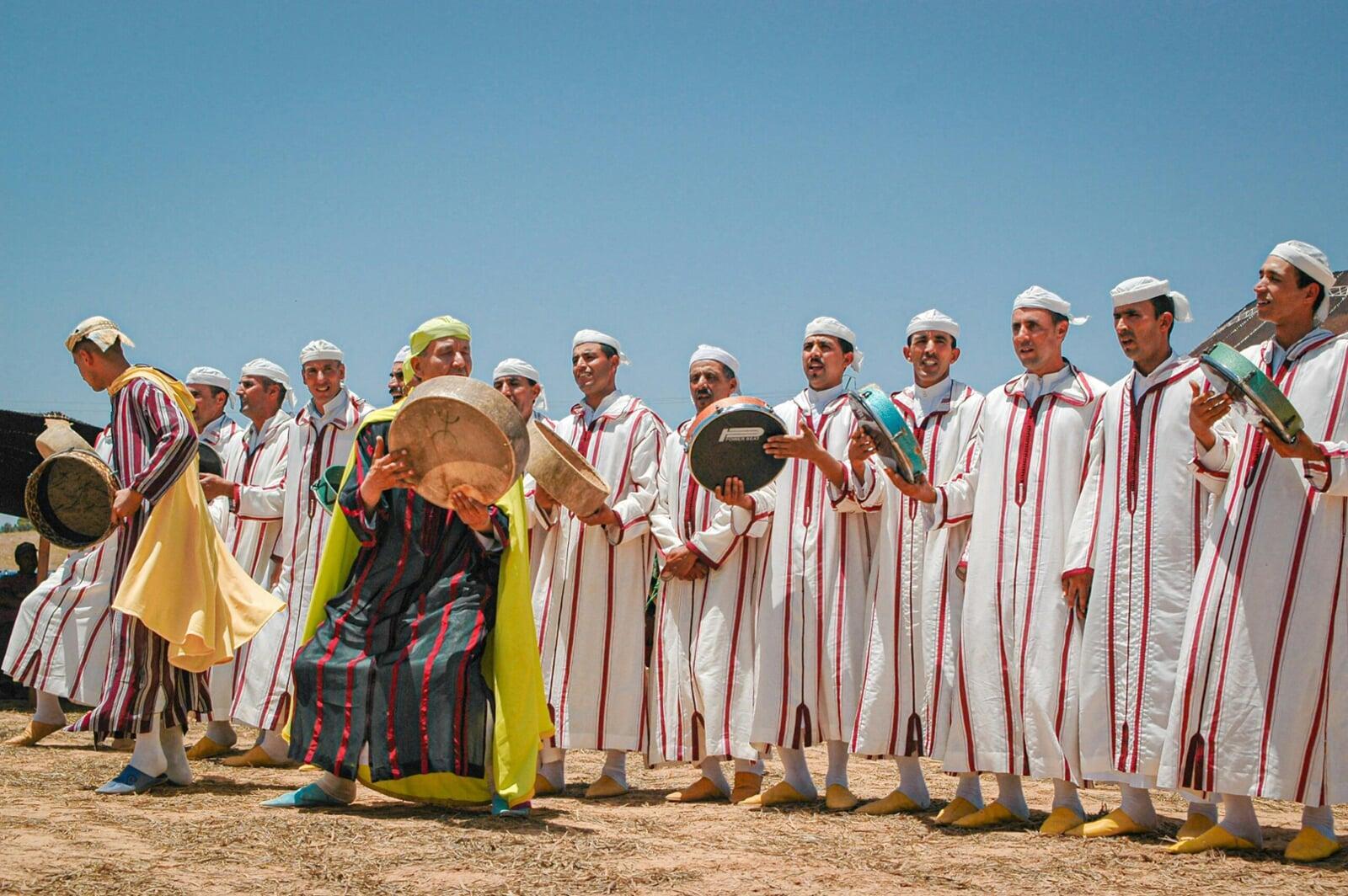 Berber musicians performing on traditional instruments in Morocco's Atlas Mountains