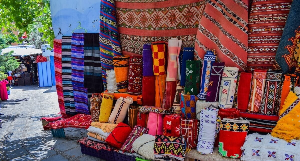 Traditional Moroccan market with colorful lanterns and textiles in Marrakech medina