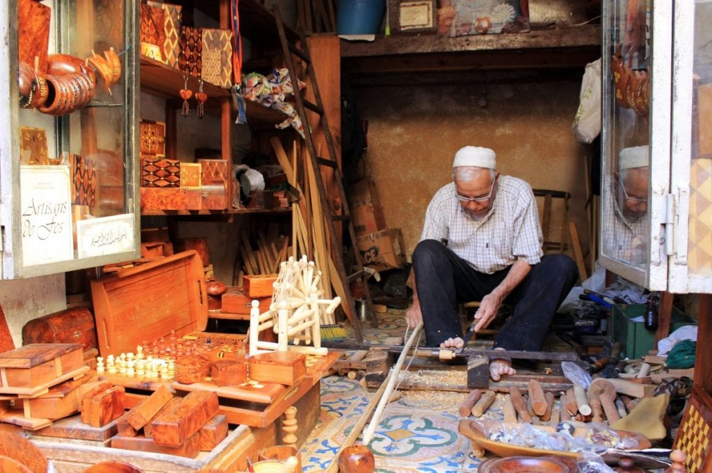 Moroccan artisan crafting traditional wood art, showcasing the country's rich craft traditions