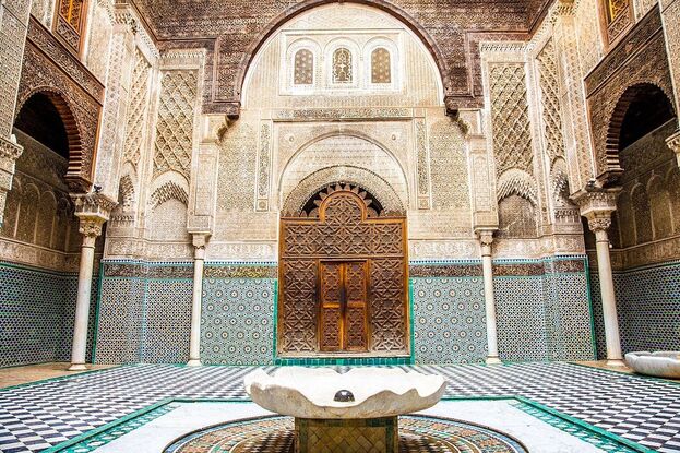 Zellige tilework and carved stucco in the Al-Attarine Madrasa courtyard, Fes